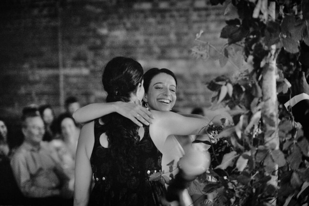 The bride hugging a wedding guest, photograph taken on film with a Leica camera.