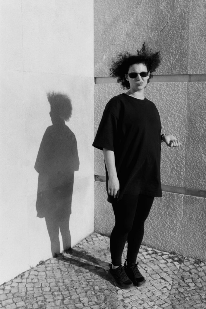Portrait of a woman with curly hair.