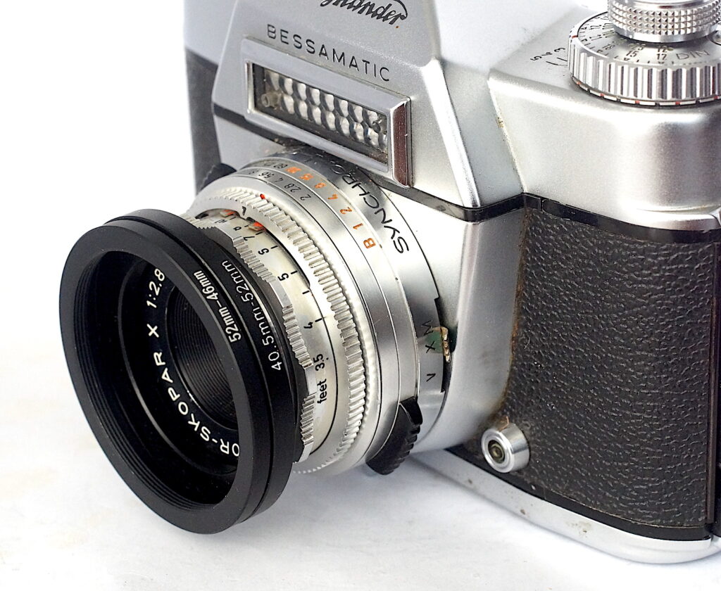 The mounting arrangement for the lenses. Acts as a lens hood too.