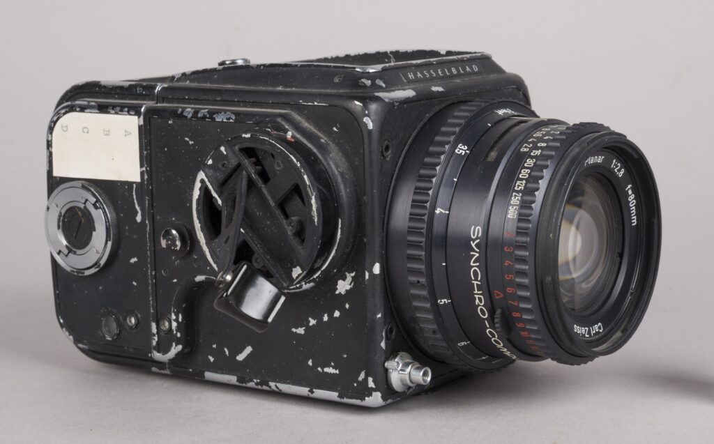 old black camera with lens and controls on the side