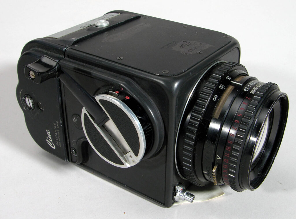 old black camera with lens and controls on the side