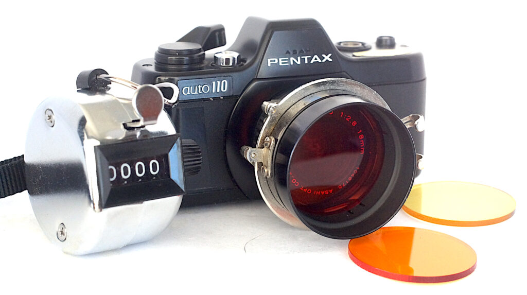 Camera with Handcross and filter in place on the wide angle lens with a clicker to keep track of exposures.