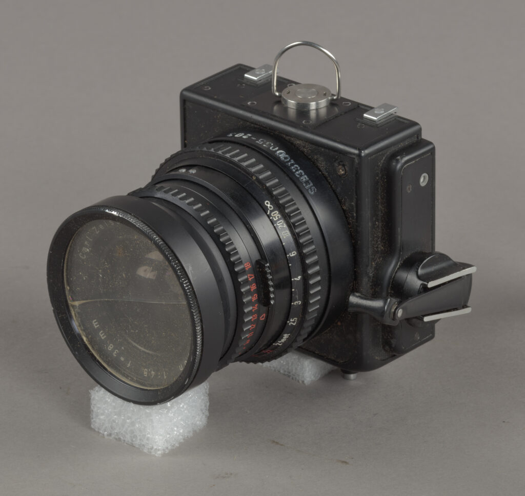 old black camera with lens and controls on the side
