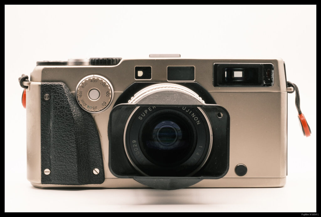 A head-on view of a Fujifilm TX-1 with the 45/4 mounted and a 3D-printed rectangular hood