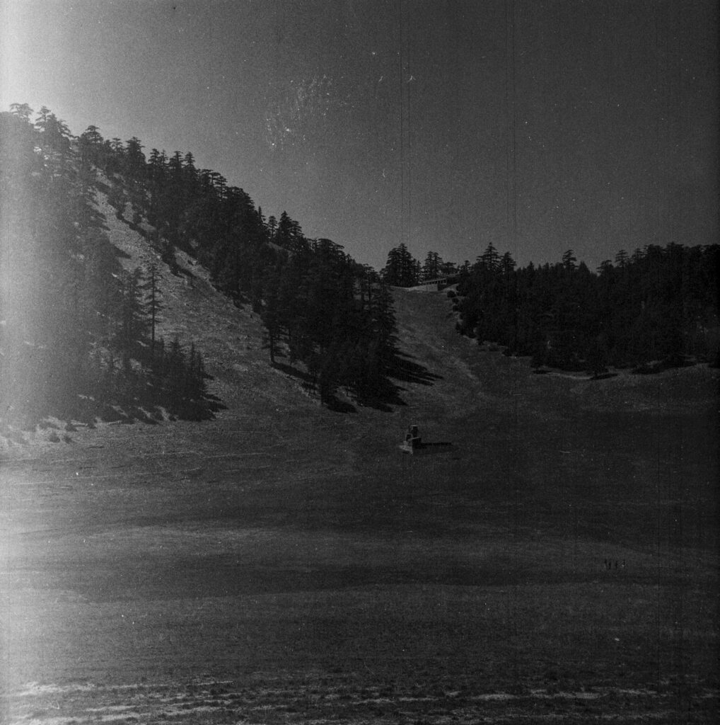 An empty field and a hillside. 