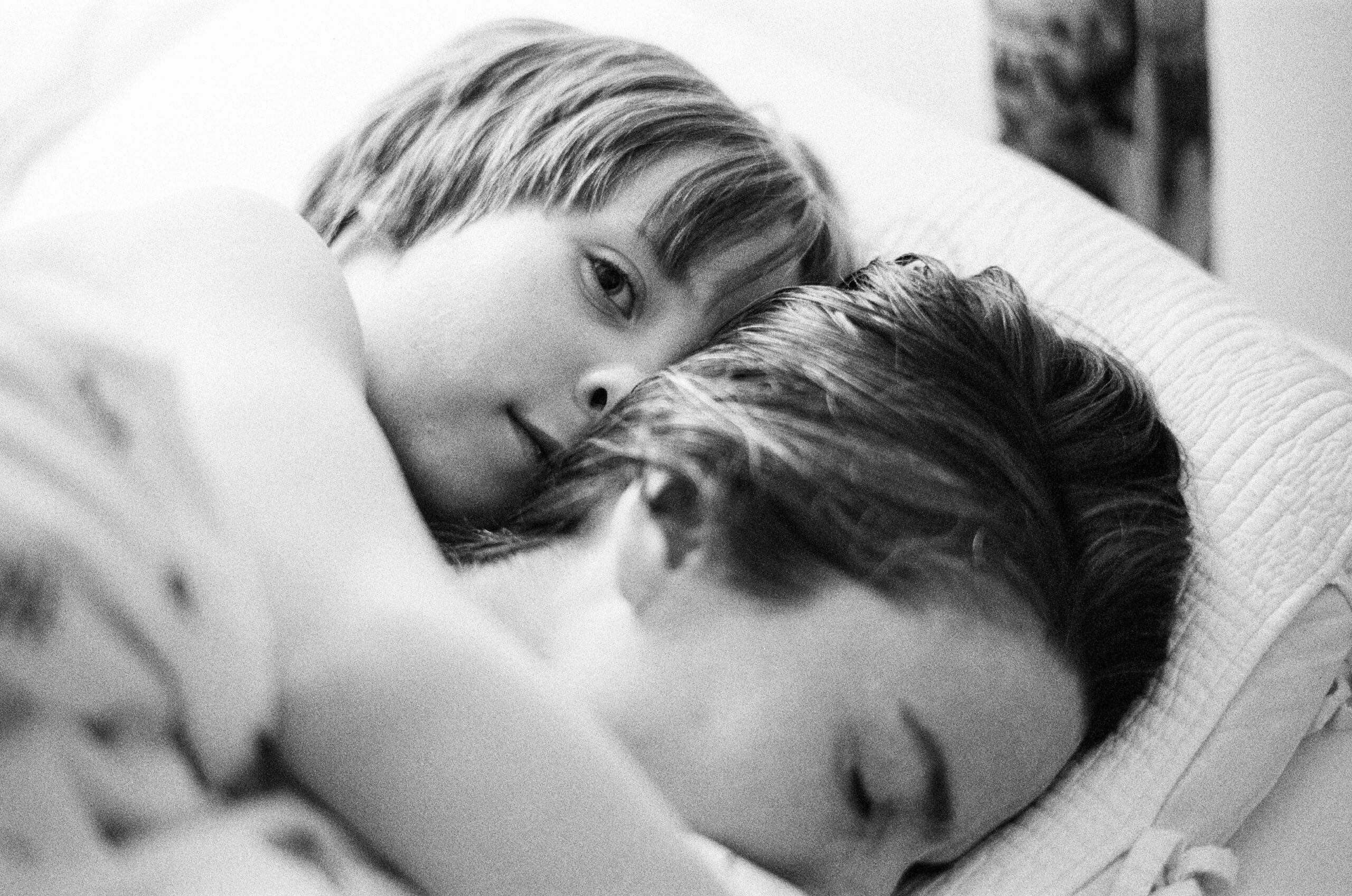 mother and son lying in bed together