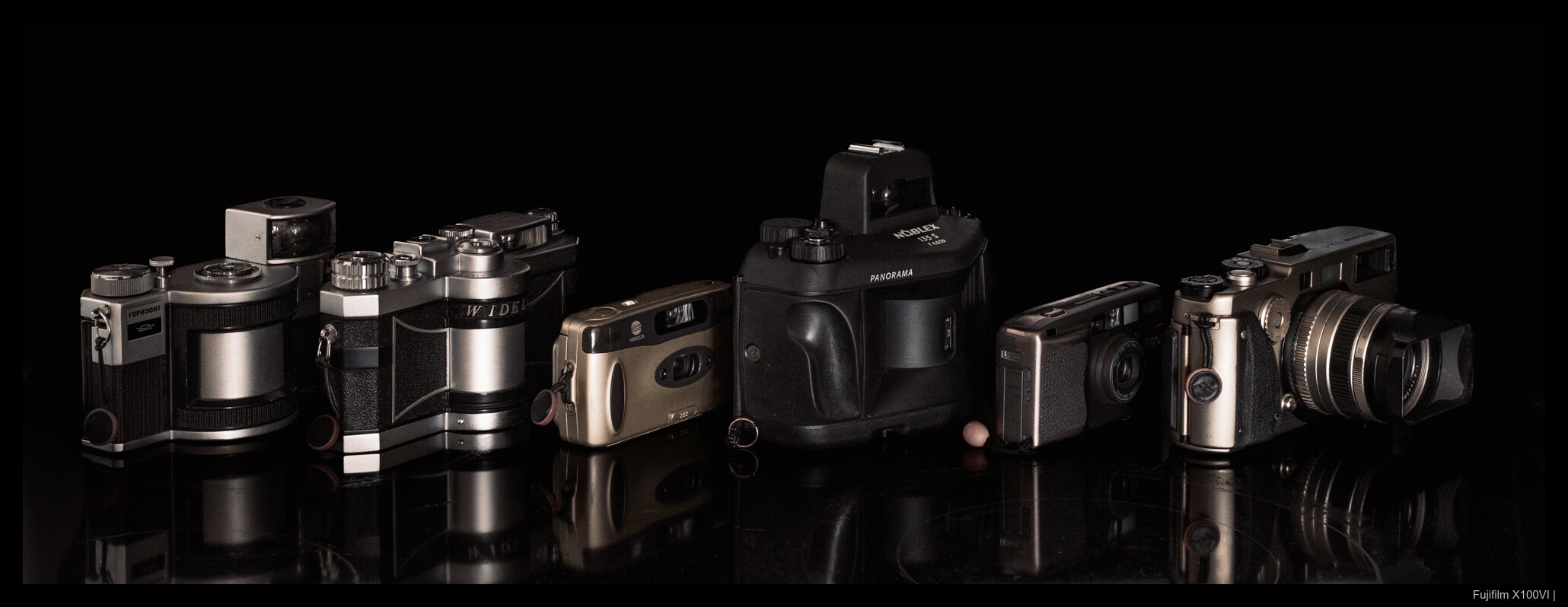 From left to right: KMZ Horizont, Panon Widelux F6, Minolta P's, KWD Noblex 135S, Ricoh R1, Fujifilm TX-1