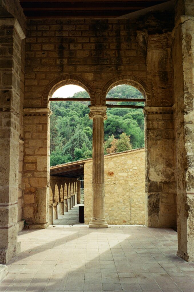2 arches in a church with an old pillar between them