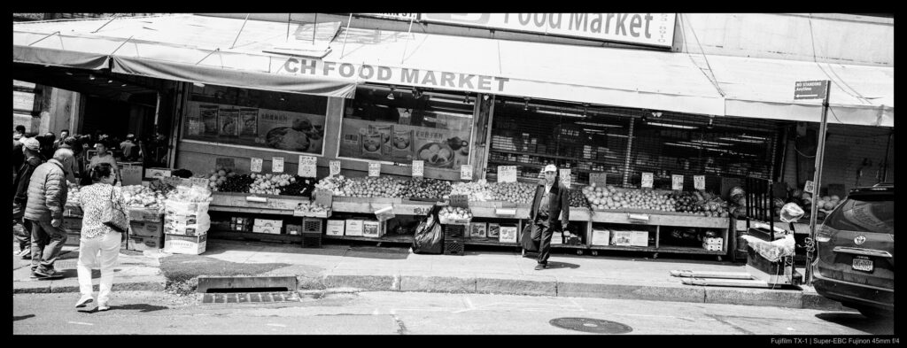 A shopper walks away from a store built into a steeply-sloped incline.