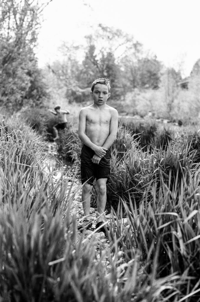 Boy standing on grassy path