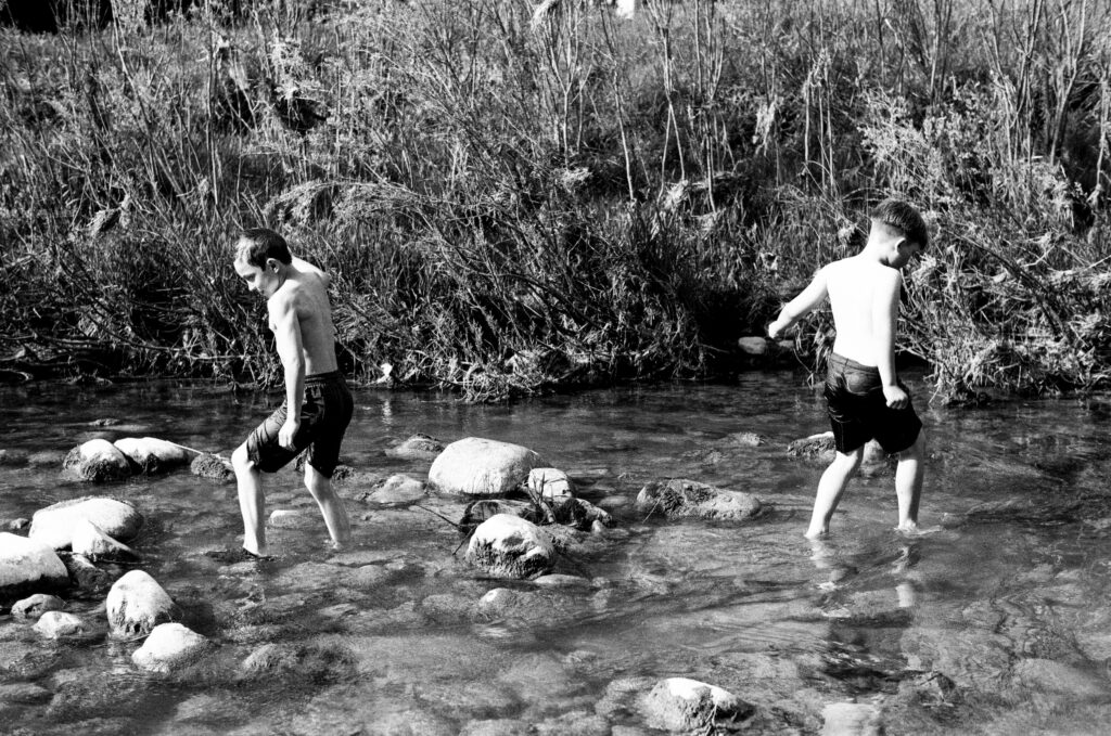 Two boys in a creek