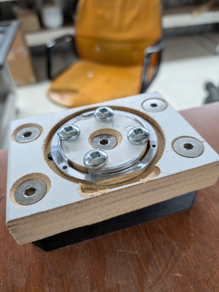 Lens mount for the Zorki being machine on an MDF fixture. It needs clearance for the rib on the bottom of the front casting.