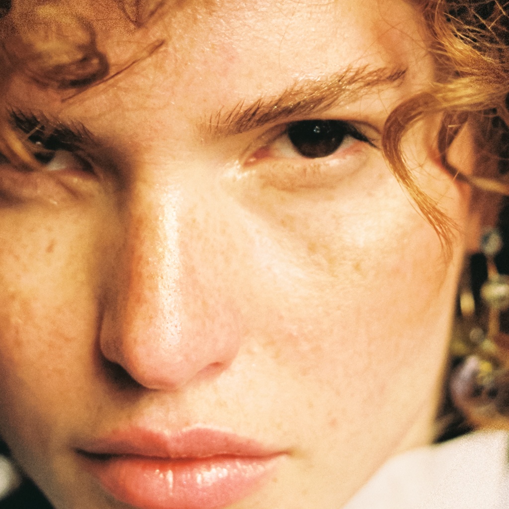100 percent crop from a 35mm Kodak Portra 400 scan, film grain visible across the skin tones