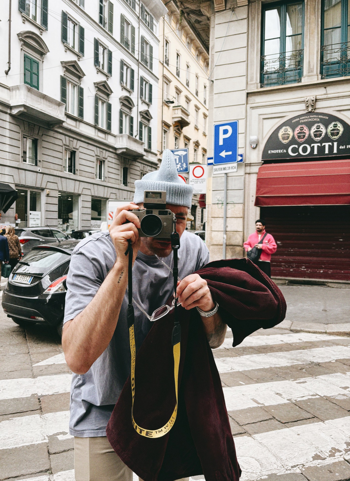 Christoph Klutsch photographing with a Contax rangefinder on a street in Milan