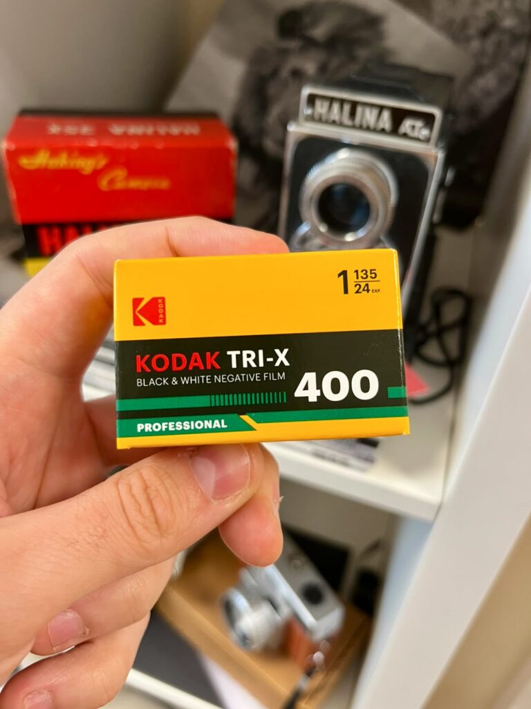 Eastman Kodak TRI-X held in front of 120 medium format camera.