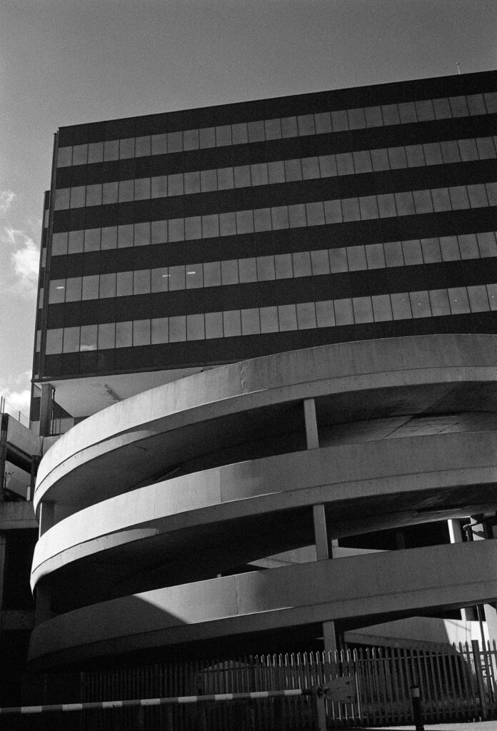 A spiral car park exit ramp, half in shadow