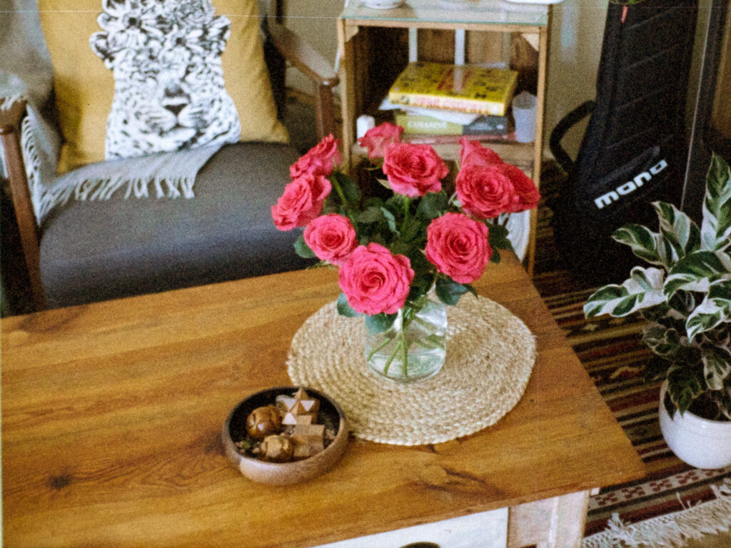 Flowers in a vase on top of a coffee table