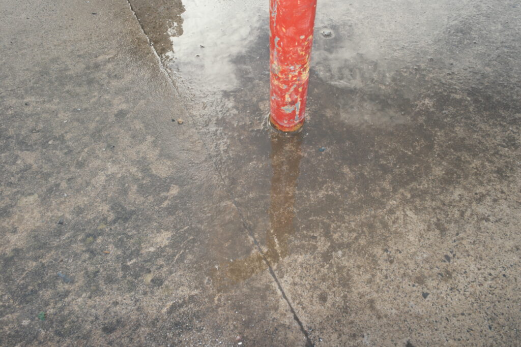 A photograph showing a puddle at the local skate park.