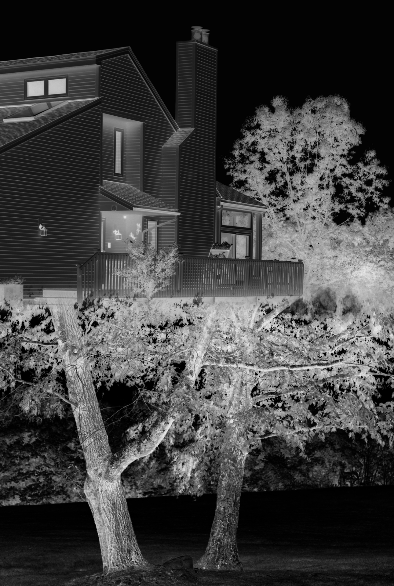 A haunted contemporary tree house perched in a tree at night.