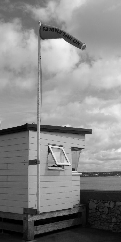 Monochrome vertical image of lifeguard hut at the beach on Dawlish Warren
