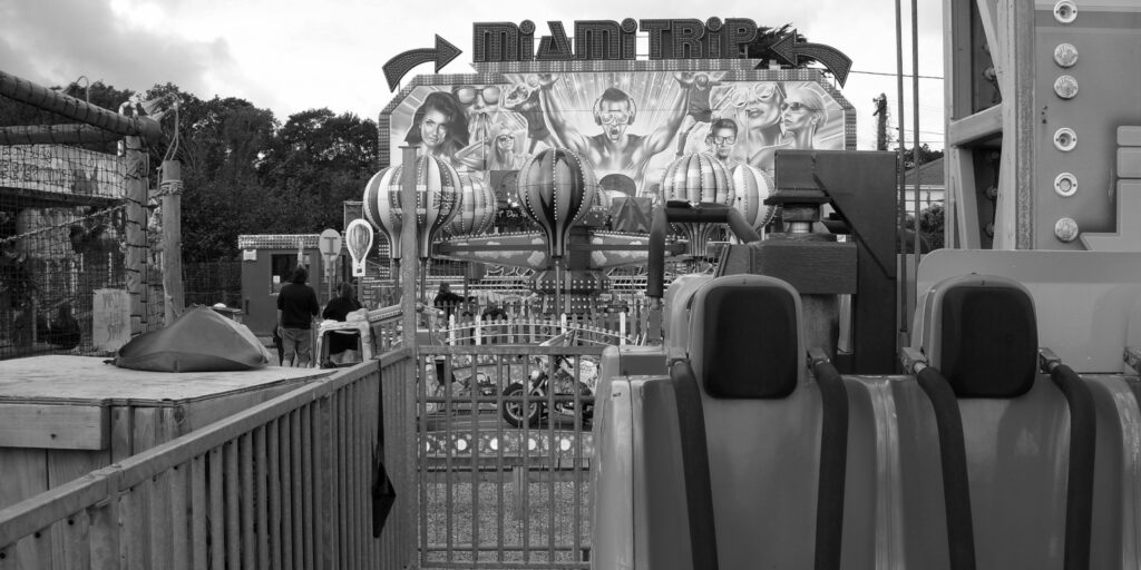 Monochrome image of the Miami Trip ride at the funfair