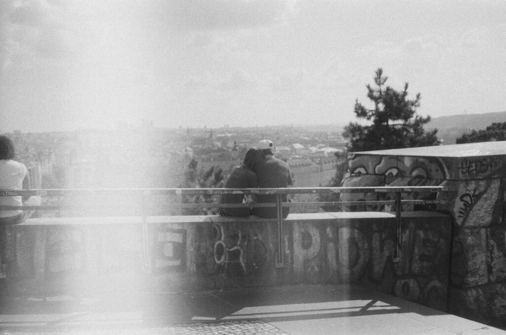 A couple sits overlooking the city
