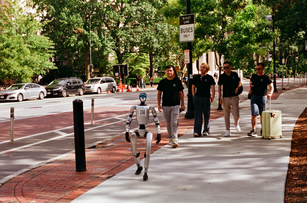A humanoid robot leading people down the street.